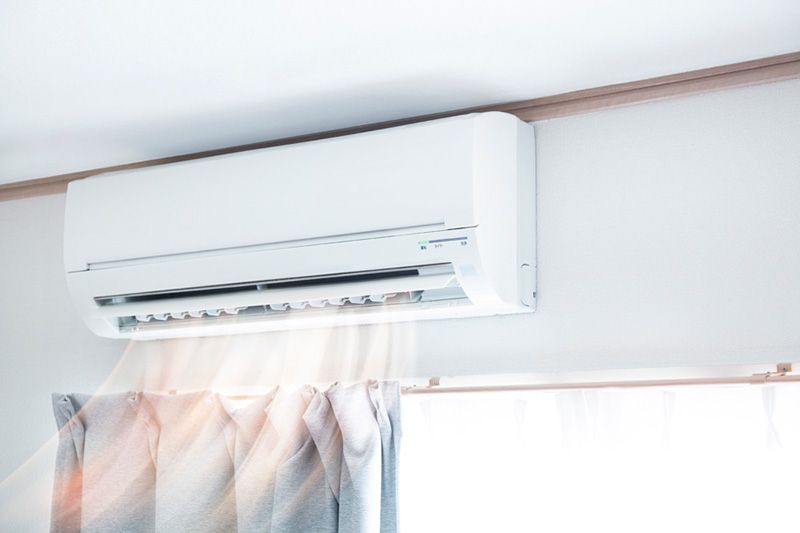 Planning to Remodel? Go Ductless! Image shows white ductless unit circulating air.