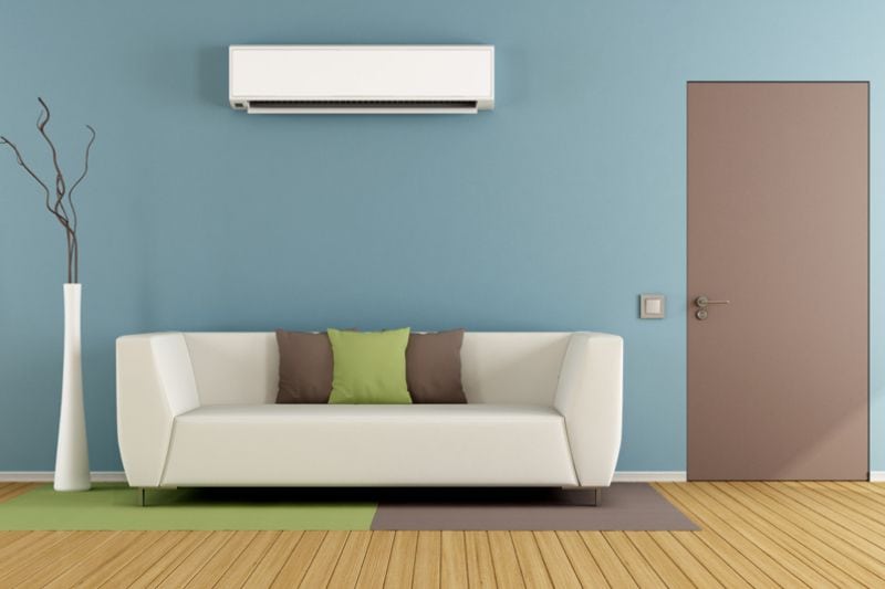 Image of a ductless system above a couch. Why Ductless Is the Way to Go.