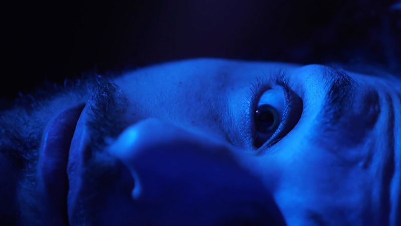 Is your AC making scary noises? Image of magnified face in blue hue.